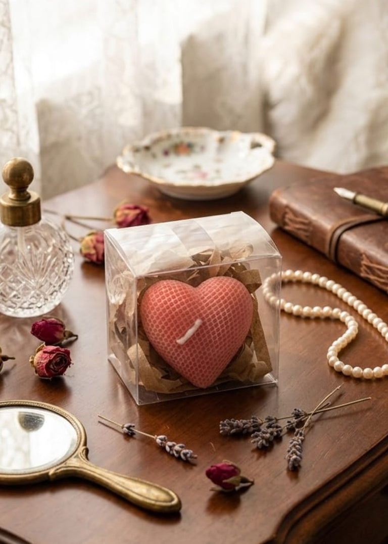 Vintage-style table setting with heart-shaped object, mirror, and decorative items.