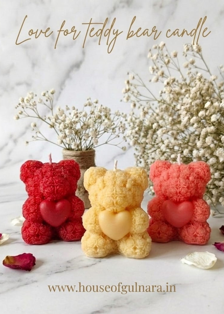 Three teddy bear-shaped candles in red, yellow, and pink on a marble surface with text 'Love for teddy bear candle' and a website URL.