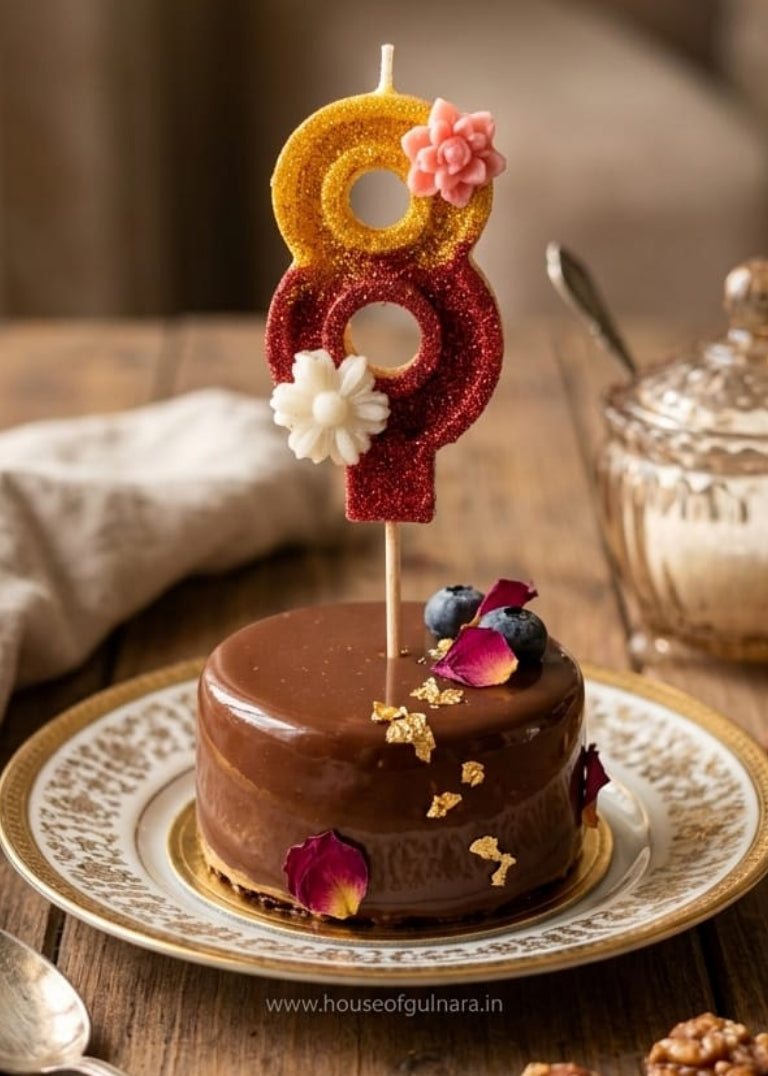 Chocolate cake with a decorative number 9 candle on a wooden table.