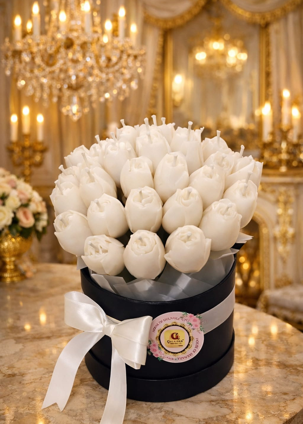 Bouquet of white tulips candle in a black box with a bow on a marble table in an elegant room.