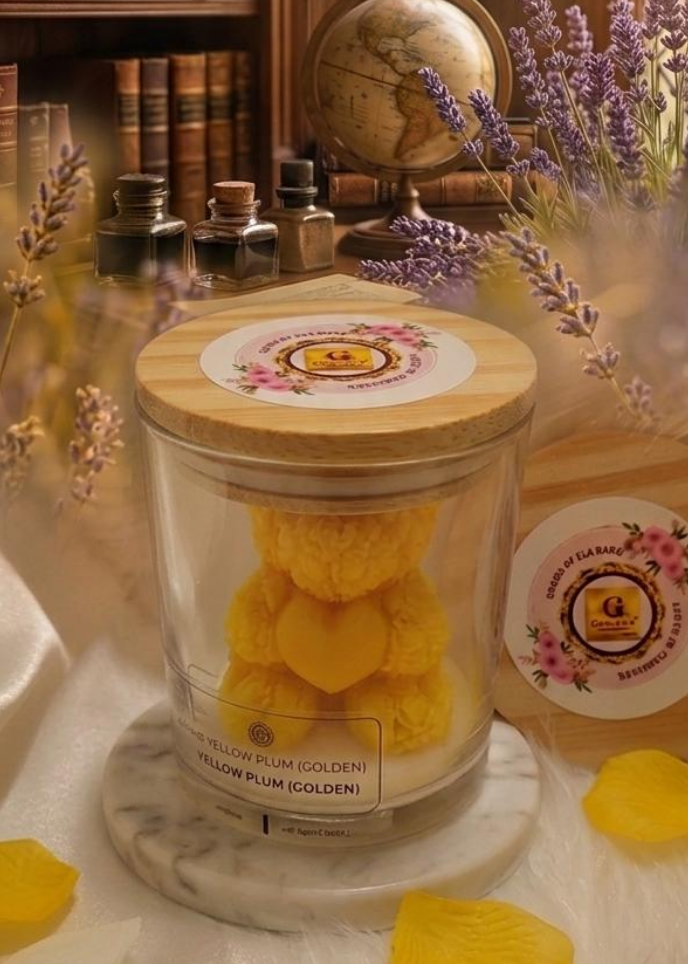 Glass jar with a yellow teddy bear inside, surrounded by lavender and yellow petals on a decorative table.