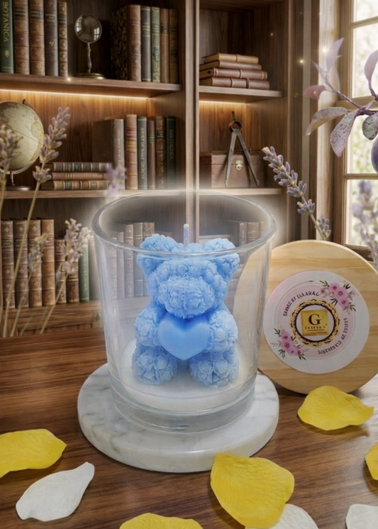 Blue teddy bear in a glass jar on a wooden surface with decorative elements.