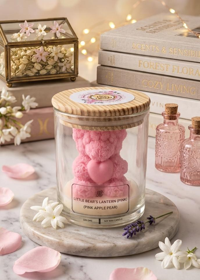 Candle in a glass jar with a wooden lid on a marble surface with flowers and books in the background.