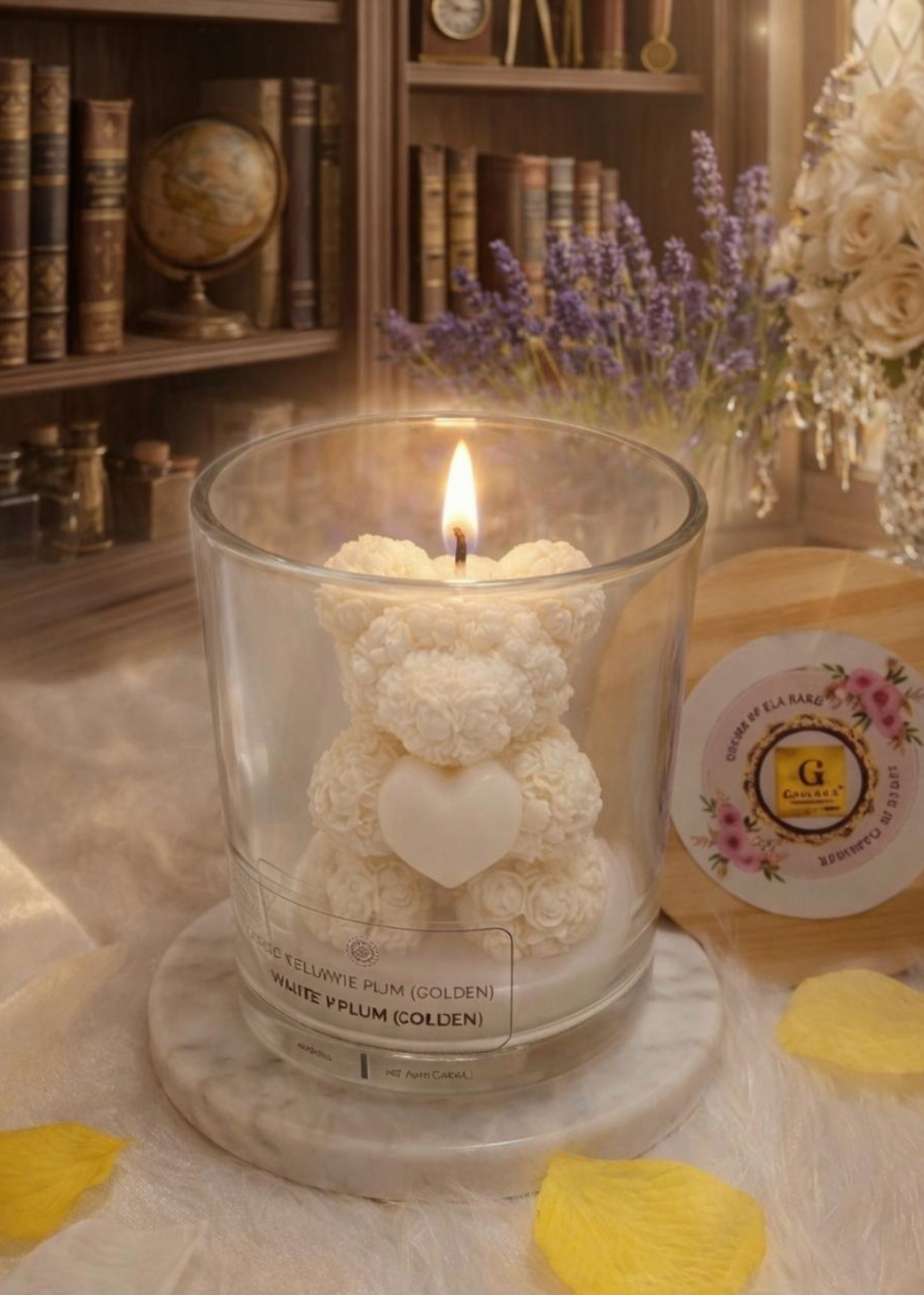 Candle in a glass holder shaped like a bear with a heart, on a table with decorative elements.