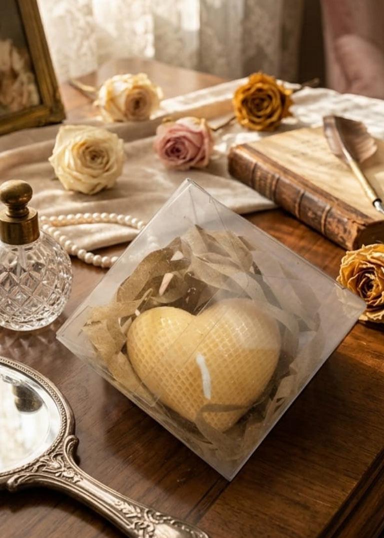 Heart-shaped object on a table with flowers and a mirror
