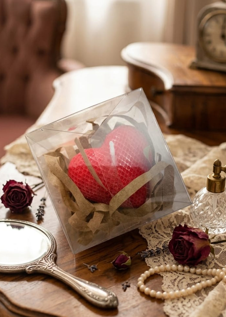 Red heart-shaped candle with stick
