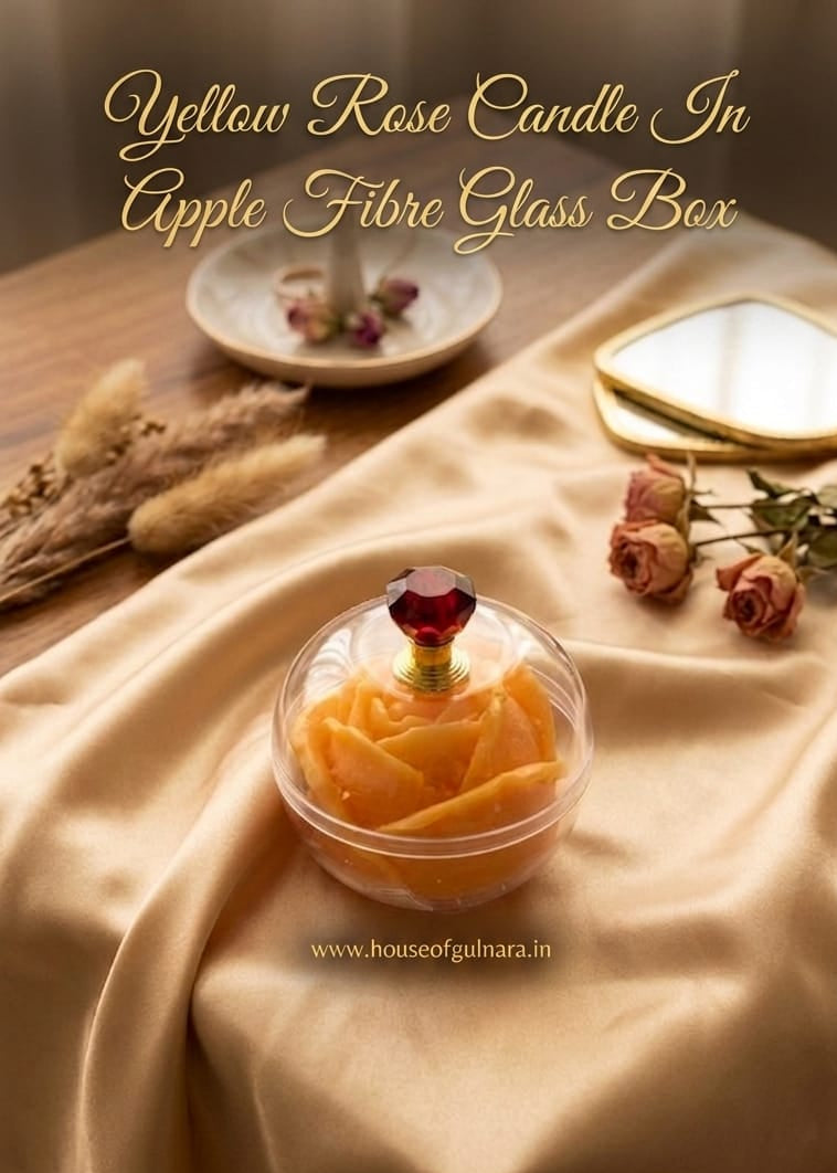 Yellow rose candle in an apple fibre glass box on a draped fabric surface with text overlay.