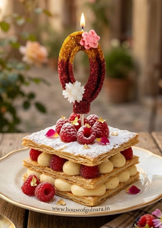 Decorative zero number floral  birthday cake with candles on a wooden table outdoors.
